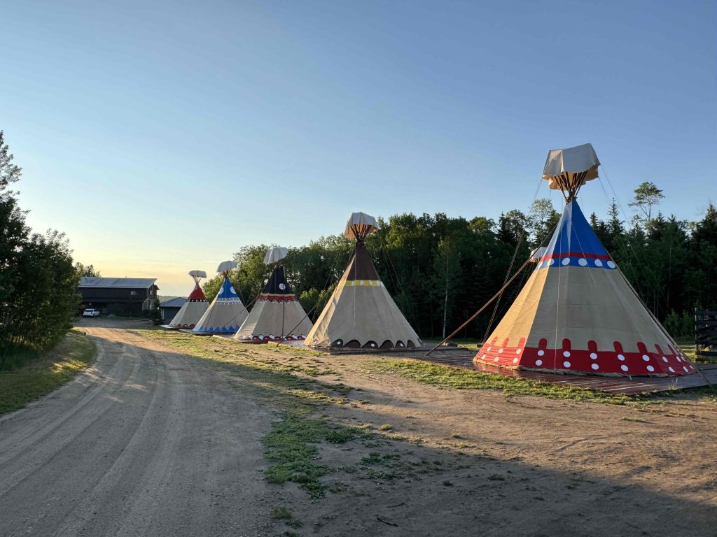 Indigenous tourism Saskatchewan teepees during the day