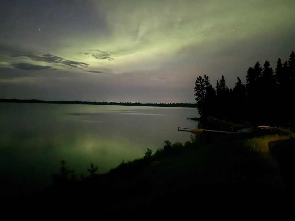 Northern Lights over the Greig Lake during Indigenous tourism Saskatchewan visit