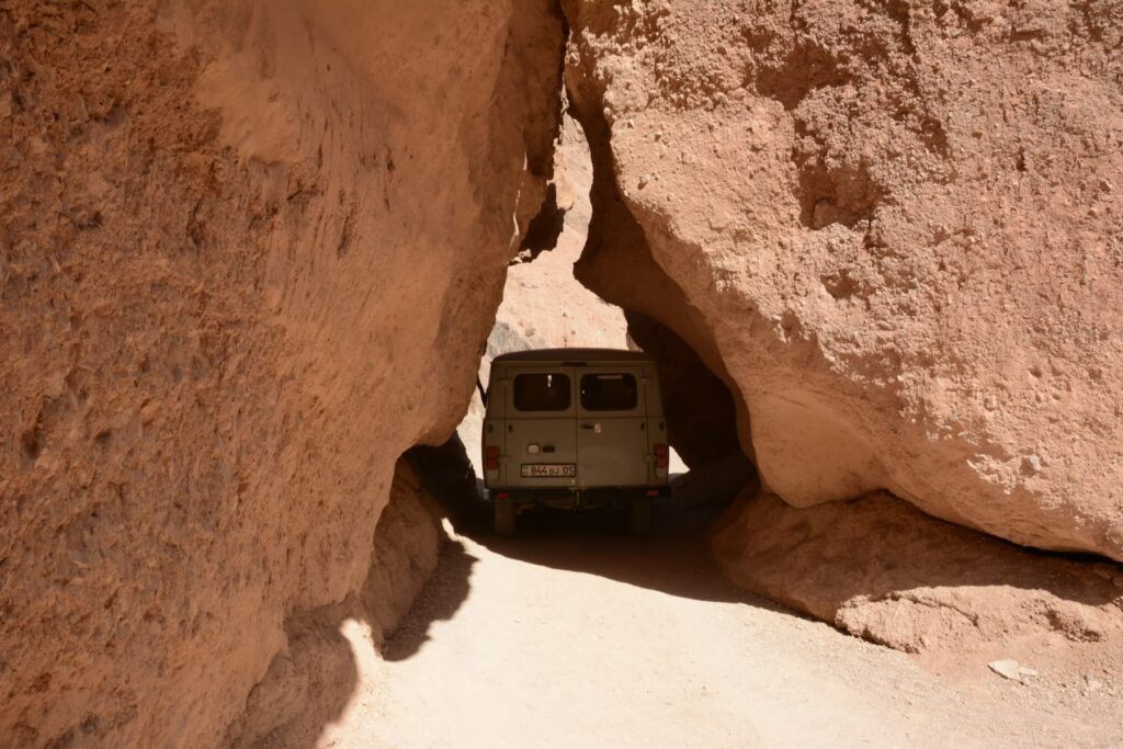 Van tight squeeze between rocks, Charyn Canyon